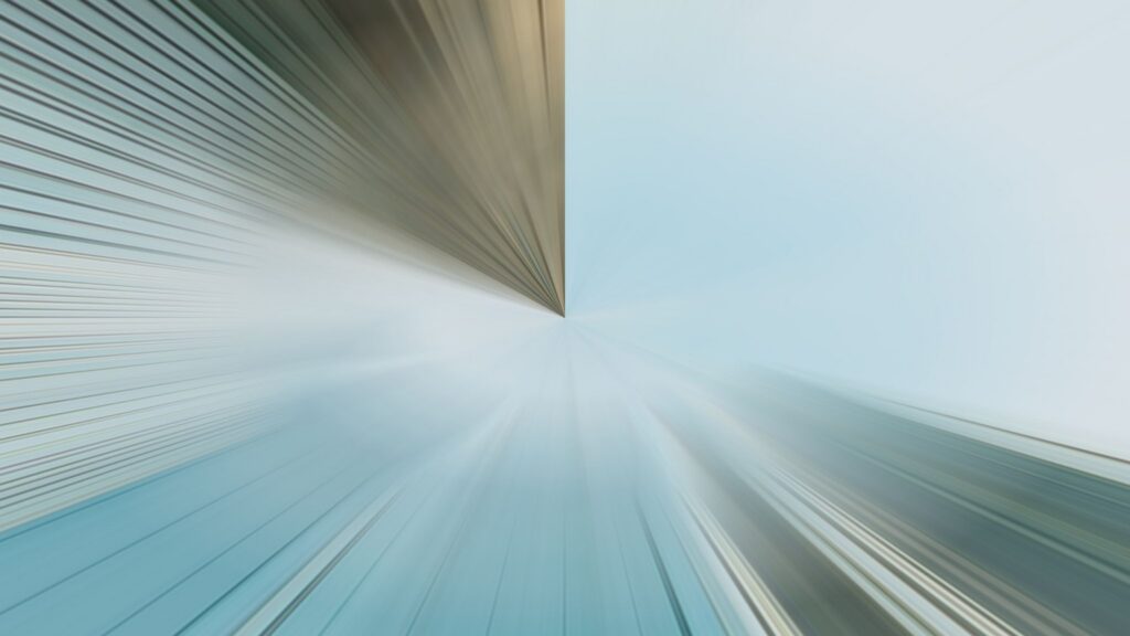 Abstract image featuring two vanishing points meeting at the center, with lines radiating outward; left side is brownish, right side is blue, creating a dynamic, futuristic visual effect.